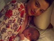 Miranda Kerr nursing son Flynn, got the memo on wearing patterns. 