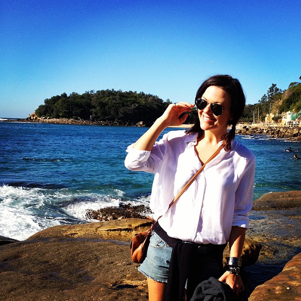 A white long-sleeved shirt balances out the shorter shorts